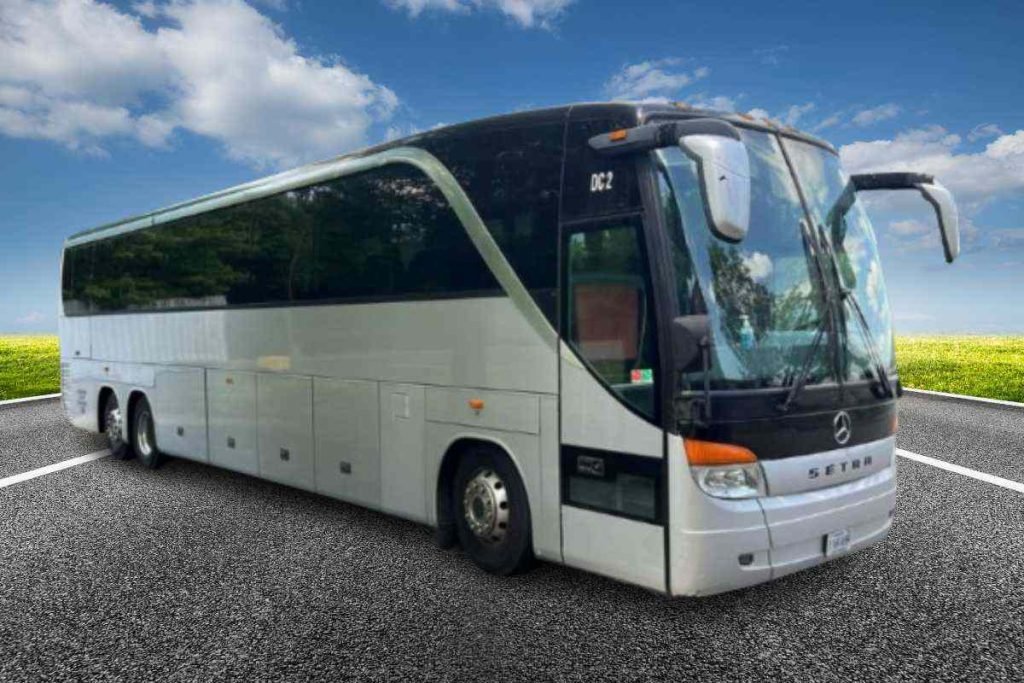 Charter Bus in white color is standing on a road
